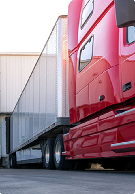 Red ELEMARI truck backed into a loading dock